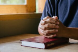 man praying with bible