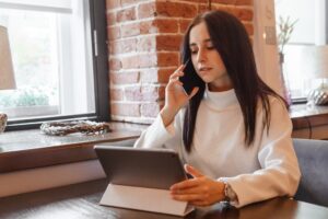 woman calling while holding a tablet